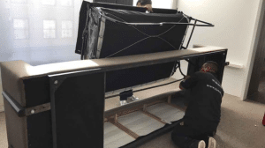 Sofa spring repair NYC — Dr. Sofa technician inspecting broken springs on a sagging couch in Manhattan